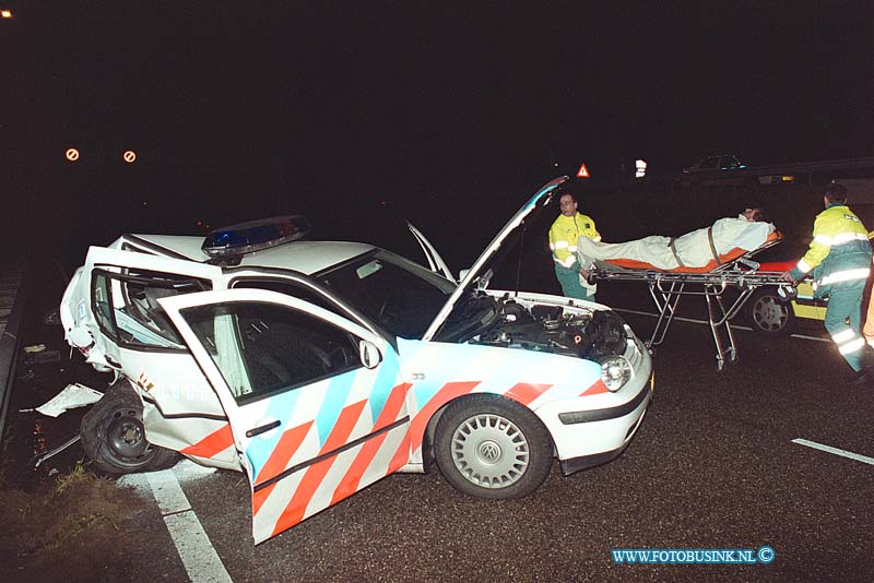 99121204.jpg - het rotterdams dagblad :Gorinchem rw a15 :12-12-1999:de politie agent uit de geramde auto kijkt nog even naar zwaar beschadige politie auto samen met de ggd broeders ongeval RW a15 een auto mobilist rijdt met zijn auto over de vluchtstrook nabij de afslag gorinchem oost op een politie auto die daar ter beveiliging stond op de vluchtstrook bij een auto met pech de bestuurder van de auto die op de politie auto inreed komt bij het ongeval om het leven de twee politie agenten die in de politie auto zaten raken zwaar gewond de bestuurder van de auto met pech raak licht gewond de rijksweg RW a15 is enkel uren voor het verkeer afgesloten geweestDeze digitale foto blijft eigendom van FOTOPERSBURO BUSINK. Wij hanteren de voorwaarden van het N.V.F. en N.V.J. Gebruik van deze foto impliceert dat u bekend bent  en akkoord gaat met deze voorwaarden bij publicatie.EB/ETIENNE BUSINK