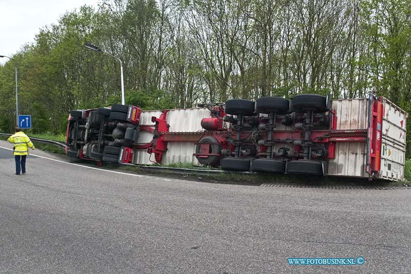 10050702.jpg - FOTOOPDRACHT:Dordrecht:07-05-2010:VRACHTWAGEN GEKANTELD DORDRECHT - Een vrachtwagencombinatie is op de N3 in Dordrecht bij de oprit naar de rijksweg A16 gekanteld. Het ongeval gebeurde op vrijdagmorgen 7 mei 2010. Het ging om een vrachtwagen met oplegger. Hierop stond een koelcontainer met daarin ongeveer 25 ton fruit. De 24-jarige chauffeur uit Alblasserdam zag kans zelf uit zijn cabine te kruipen. Wel plaatste de brandweer een trap zodat de bestuurder naar beneden kon. Hij had een lichte hoofdwond. Mogelijk reed de vrachtwagencombinatie te snel in de bocht waardoor het voertuig kantelde.Deze digitale foto blijft eigendom van FOTOPERSBURO BUSINK. Wij hanteren de voorwaarden van het N.V.F. en N.V.J. Gebruik van deze foto impliceert dat u bekend bent  en akkoord gaat met deze voorwaarden bij publicatie.EB/ETIENNE BUSINK