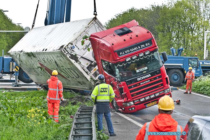 10050709.jpg - FOTOOPDRACHT:Dordrecht:07-05-2010:Foto: Het Bergen van de gekantelde Vrachtwagen. VRACHTWAGEN GEKANTELDDORDRECHT - Een vrachtwagencombinatie is op de N3 in Dordrecht bij de oprit naar de rijksweg A16 gekanteld. Het ongeval gebeurde op vrijdagmorgen 7 mei 2010. Het ging om een vrachtwagen met oplegger. Hierop stond een koelcontainer met daarin ongeveer 25 ton fruit. De 24-jarige chauffeur uit Alblasserdam zag kans zelf uit zijn cabine te kruipen. Wel plaatste de brandweer een trap zodat de bestuurder naar beneden kon. Hij had een lichte hoofdwond. Mogelijk reed de vrachtwagencombinatie te snel in de bocht waardoor het voertuig kanteldeDeze digitale foto blijft eigendom van FOTOPERSBURO BUSINK. Wij hanteren de voorwaarden van het N.V.F. en N.V.J. Gebruik van deze foto impliceert dat u bekend bent  en akkoord gaat met deze voorwaarden bij publicatie.EB/ETIENNE BUSINK